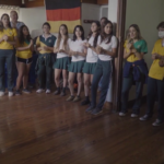 jovenes escolares reunidos aplaudiendo y cantando